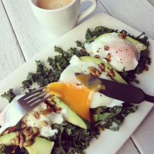 Poachies on lightly fried kale sprinkled with child roasted pumpkin seeds